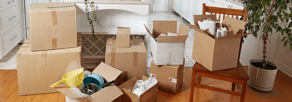 Packed moving boxes and household items in a kitchen before move-out or move-in cleaning, Shreveport, LA.